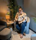 RN Psychotherapist, Stephanie Edmonds smiling, siting in a chair